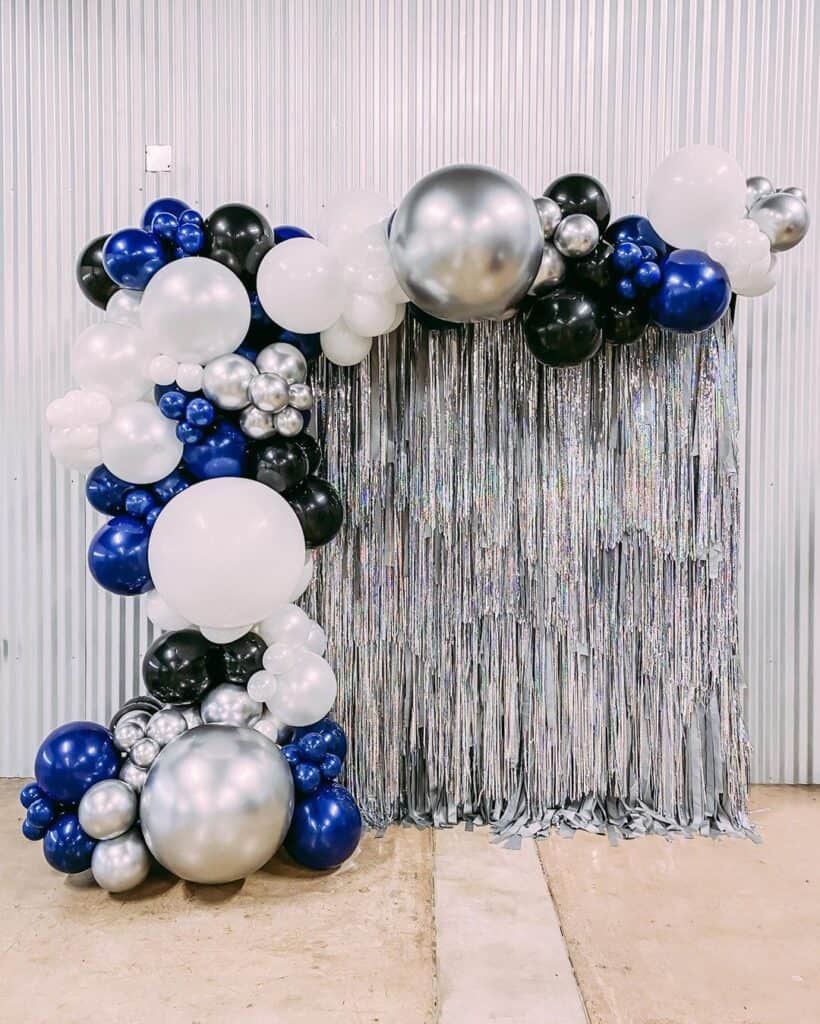 silver, black, and white graduation party backdrop and balloons