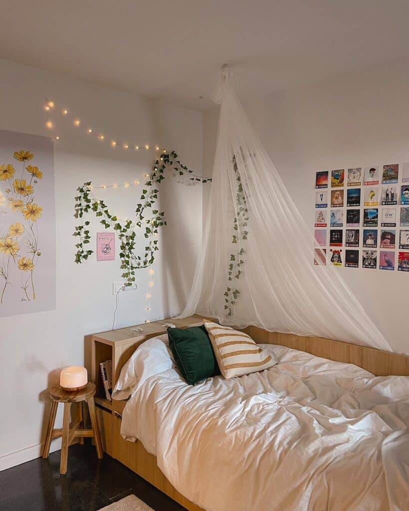 Dorm room for college using greenery garland and hanging lights to decorate it. 