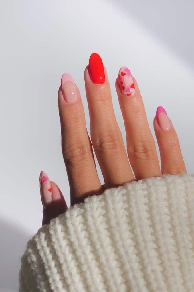 red and pink Valentine's nails with mini hearts